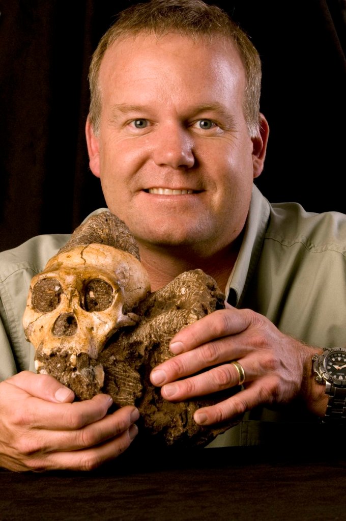Lee R. Berger of the University of Witwatersrand in South Africa holds the 2 million-year-old cranium of Australopithecus sediba, found in South Africa.