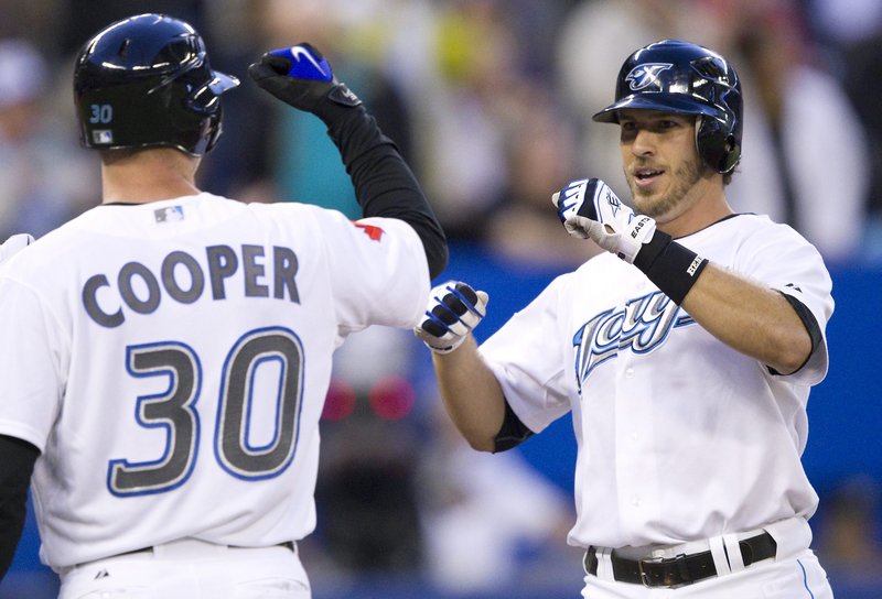 David Cooper welcomes J.P. Arencibia, who hit a three-run homer in the second inning Thursday night for the Toronto Blue Jays in the 7-4 victory against Boston.