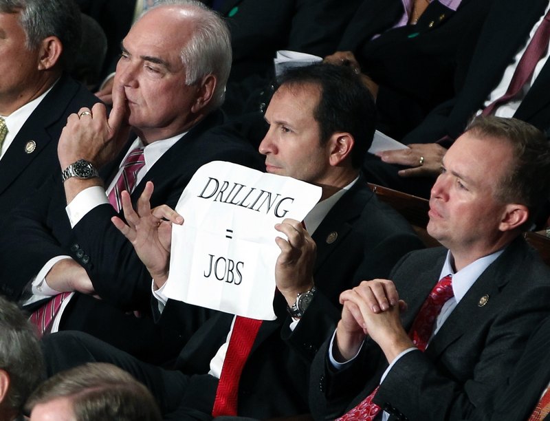 Rep. Jeff Landry, R-La., holds a sign during President Barack Obama's speech to a joint session of Congress at the Capitol in Washington on Thursday night. Republicans mostly expressed their dissent by sitting silently.