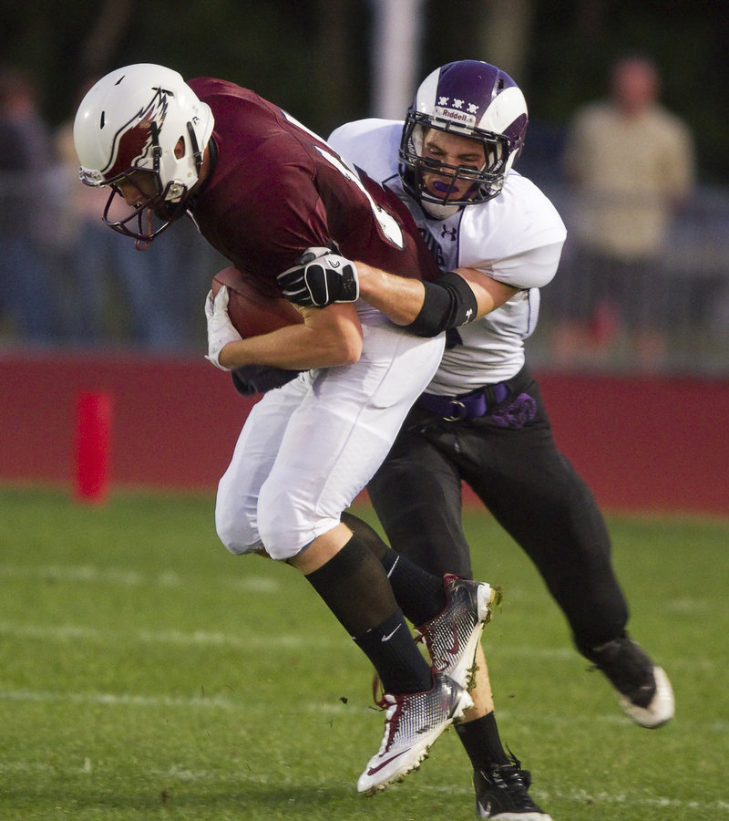 Defensive back Nick DiBiase of Deering isn't letting Windham quarterback T.D. O'Brien go anywhere Friday night during their Western Class A game at Windham High. O'Brien did rush for 157 yards, but Deering improved its record to 2-0 with a 28-20 victory.