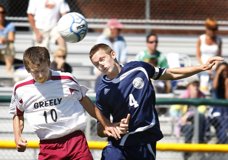 Matt Crowley, left, of Greely and Paul Kurnick of Fryeburg Academy compete for the ball Saturday during their Western Maine Conference schoolboy soccer game. Greely won 2-1 in the final second of the second overtime.