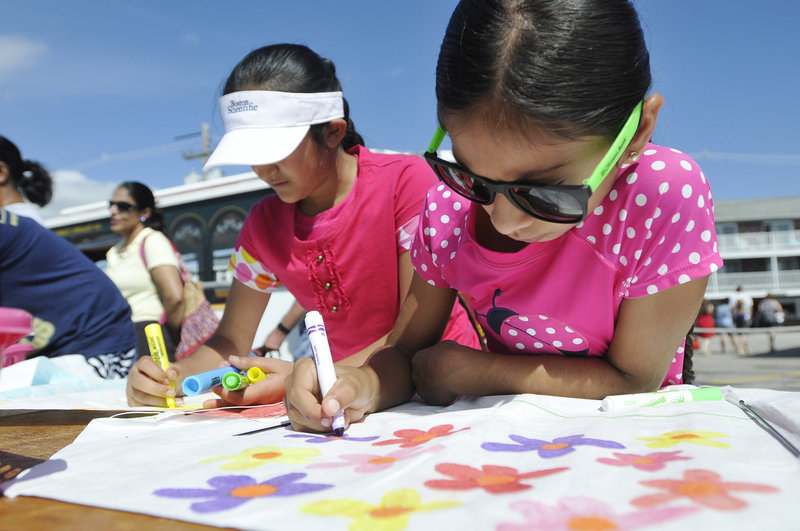 Jupna Kaur, 11, left, and Tara Bhasin, 9, both of Boston, create their kites.