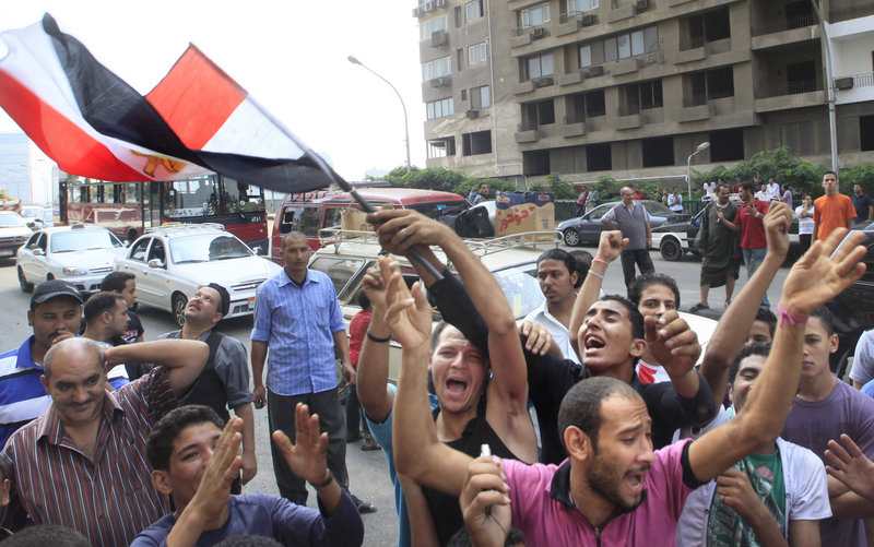 Egyptian activists wave their national flag near the Nile-side Israeli embassy in Cairo, Egypt, on Saturday.