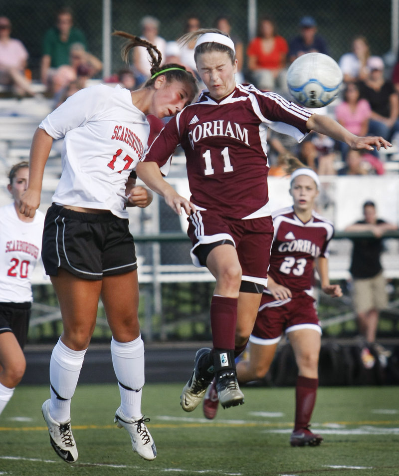Jessica Broadhurst, left, of Scarborough and Kiersten Turner of Gorham react after a throw-in is headed away. Moving in are Ashley Ronzo, left, of Scarborough and Kate Hopkins of Gorham.