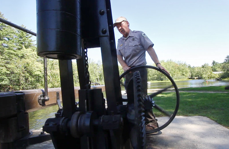 Sam Chute of the Maine Department of Conservation operates the hand-turned mechanism that opens and closes the Songo Lock. Passing through the historic lock has been one attraction of riding on the Songo River Queen II.