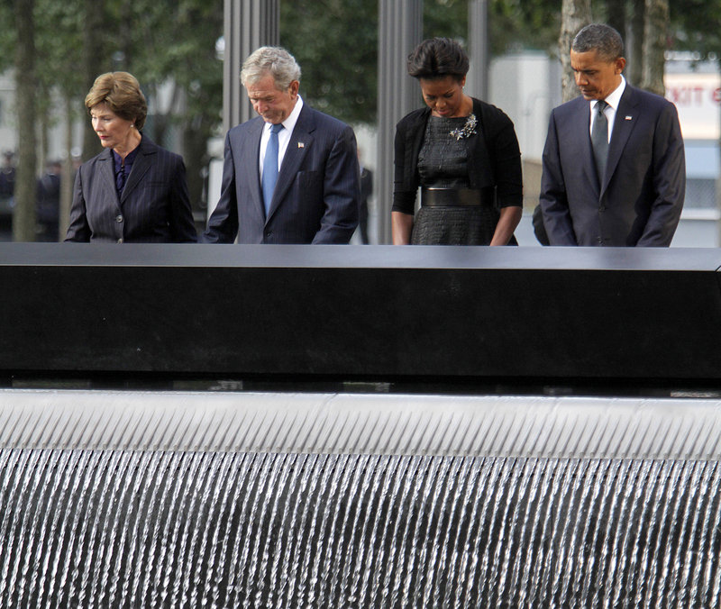 A moment of silence is observed by, from left, former first lady Laura Bush, former President George W. Bush, first lady Michelle Obama and President Obama at the National September 11 Memorial in New York on Sunday.