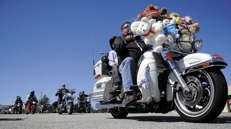 Motorcyclists pull out of Augusta at the start of the annual toy run sponsored Sunday by the United Bikers of Maine. The annual ride, attended by thousands, wound up in Windsor where bikers donated toys for children.