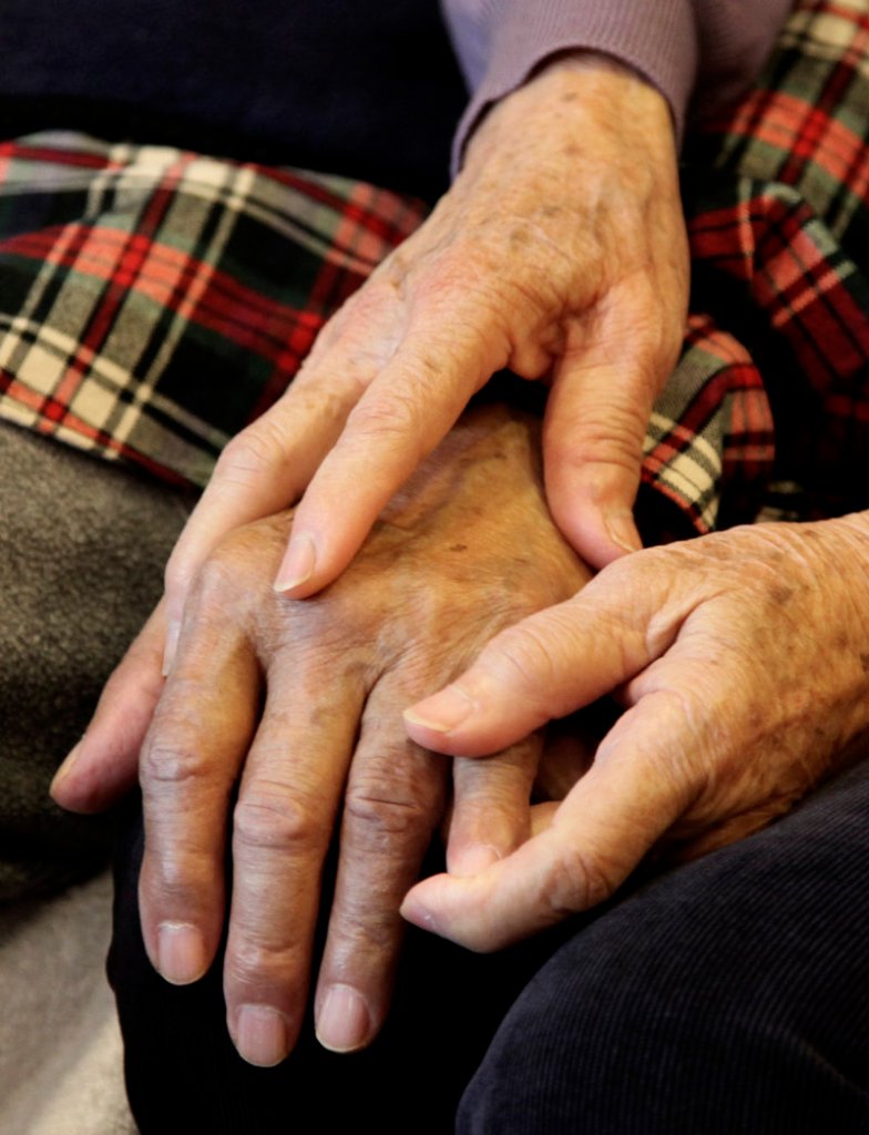 Shou-Mei Li holds the hand of her husband, Hsien-Wen Li, an Alzheimer’s patient. By 2050, 13 million to 16 million Americans are projected to have Alzheimer’s, costing $1 trillion in medical expenses.