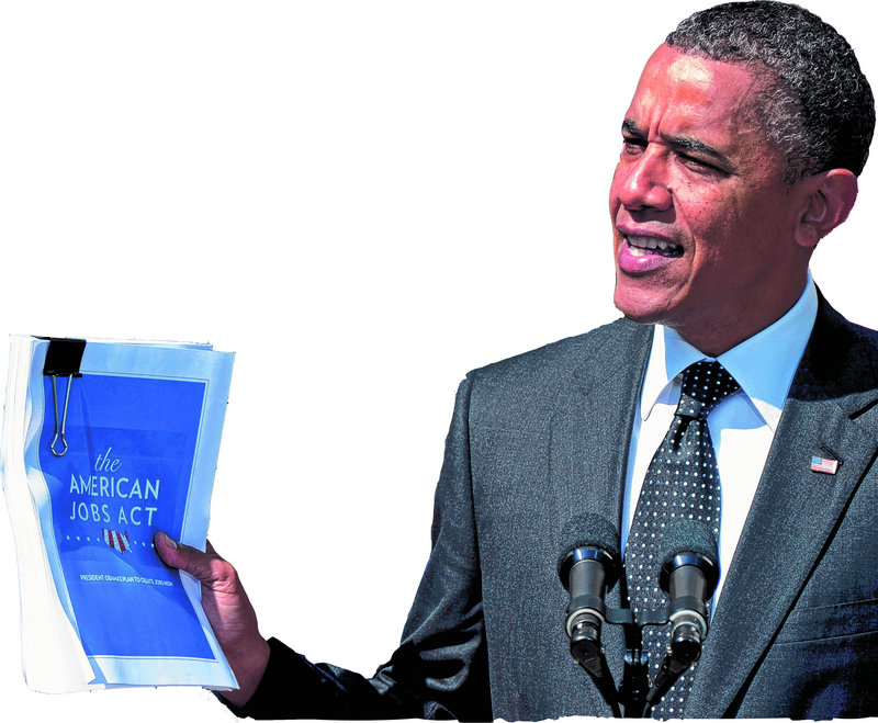 President Obama holds up a copy of his American Jobs Act during a statement at the White House in Washington on Monday.