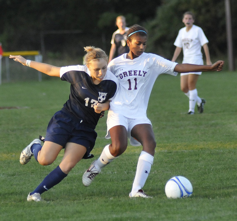 York’s Hannah Daigneault fights for the ball with Greely’s Samantha Kennedy on Monday in Cumberland. Greely won, 1-0.