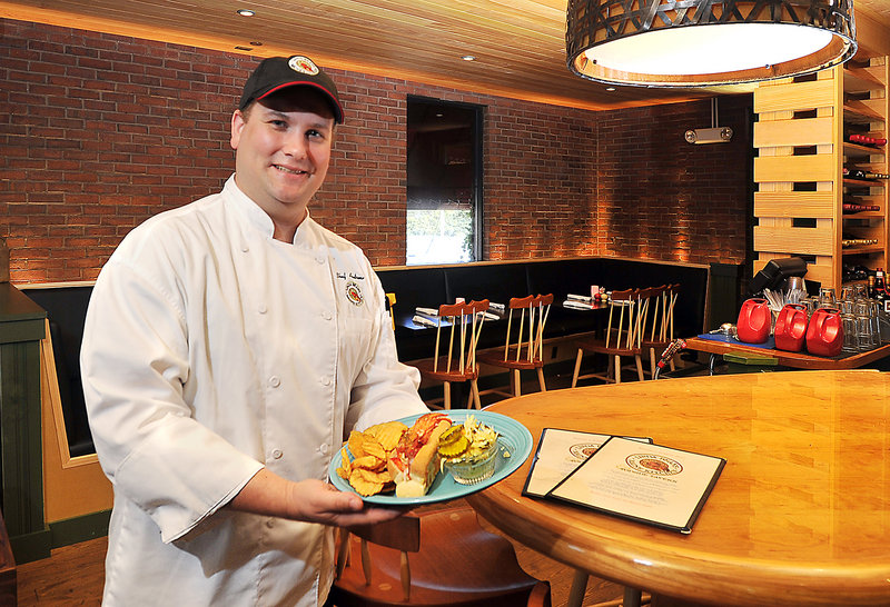 Chef Andrew Omo presents the “Perfect Maine Lobster Roll” at Linda Bean’s Maine Kitchen and Topside Tavern in Freeport across from L.L. Bean. Sides include Kelpislaw and house-made salt and vinegar chips.