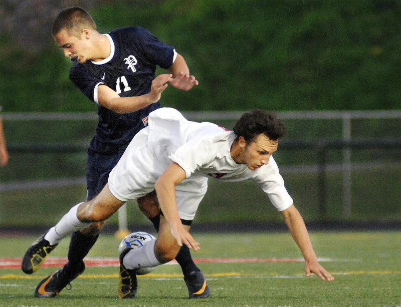 Andrew Jones of Scarborough takes a tumble after running into Paley Burlin of Portland during an SMAA boys’ soccer game Tuesday night at Scarborough. The teams played to a 0-0 tie.