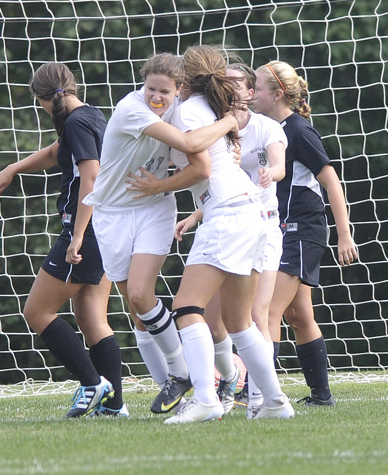 Becky Smith of Waynflete, left, hugs teammate Ella Millard after Millard scored the first goal Wednesday of an 8-0 victory against North Yarmouth Academy in Portland. Smith finished with two goals for the Flyers, who improved to 2-1. NYA is 0-4.