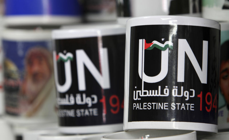 Cups designed as part of the campaign promoting the Palestinians bid for statehood are displayed in a souvenirs shop in Gaza City,