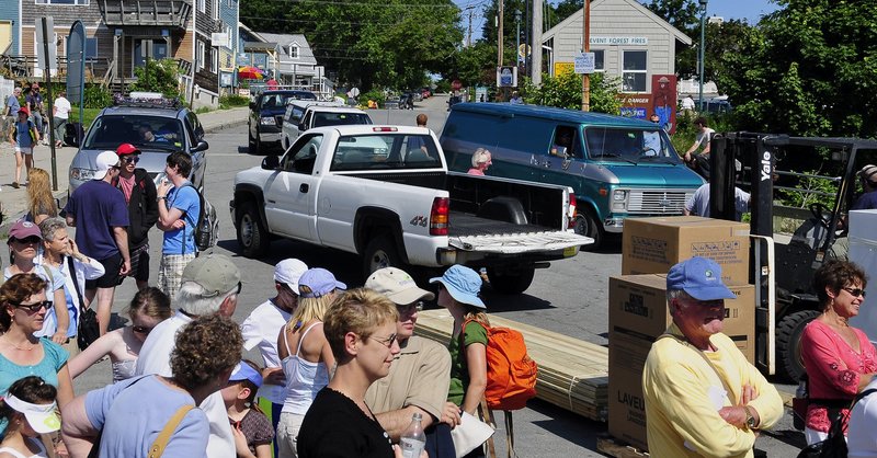 In a ‘Peaks Island rush hour,’ people and vehicles line up to board the ferry to the mainland. A reader wonders if perhaps, compared to other Maine island property owners, he might be paying too much for the privilege.