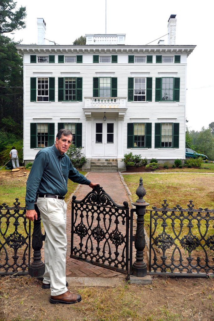 Maine Preservation Executive Director Greg Paxton shows off the restored cast-iron fence.