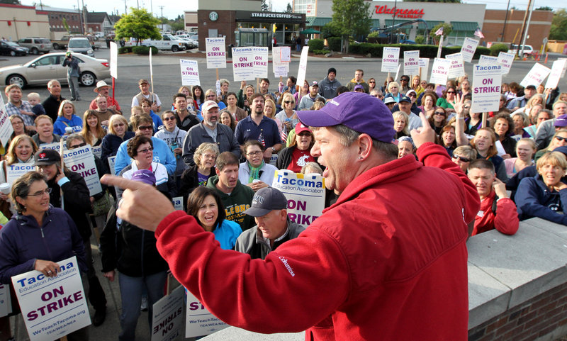 Dave Baughman cheers on striking teachers in Tacoma, Wash., on Thursday. Teachers in Washington state’s third-largest school district voted overwhelmingly to remain on strike, in defiance of a judge’s order that they return to work.