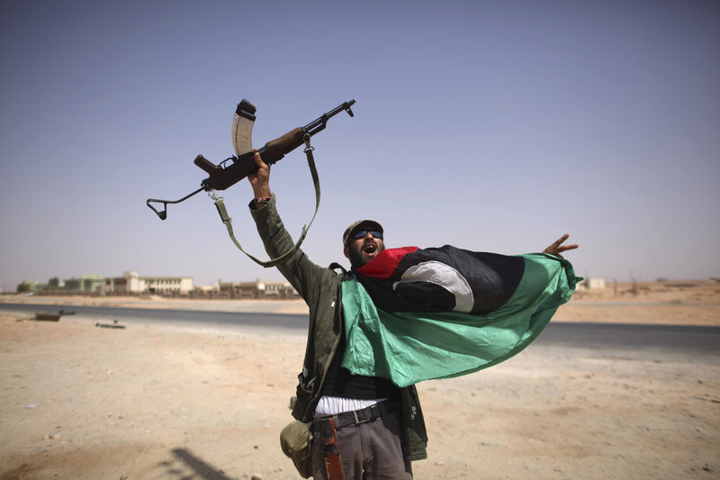 A Libyan fighter celebrates in Bani Walid, Libya, Friday. Libyan fighters are streaming into Bani Walid, one of the remaining bastions of ousted leader Moammar Gadhafi, in a new fierce push.