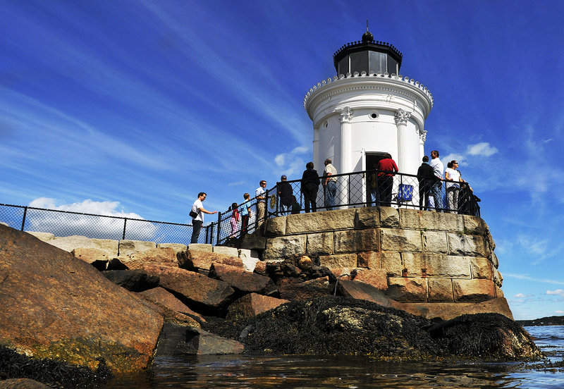 People gather around Bug Light in South Portland on Saturday during Open Lighthouse Day, when lighthouses along the coast are open to visitors.