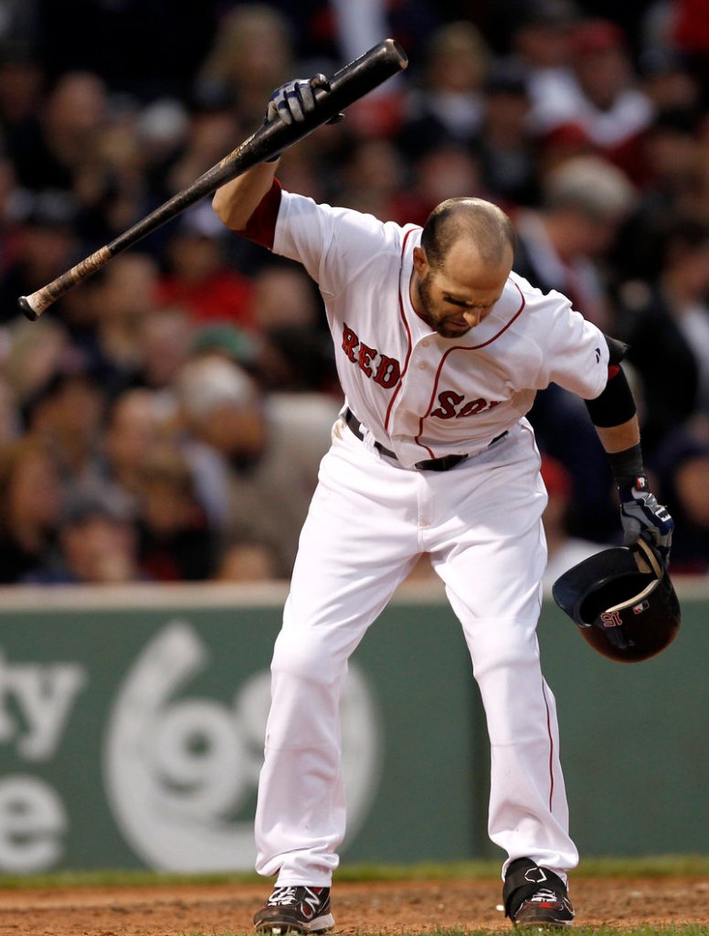 Dustin Pedroia throws his bat down after striking out to end the seventh inning. He finished 0 for 4 and the Red Sox saw their lead in the AL wild-card race cut to three games.
