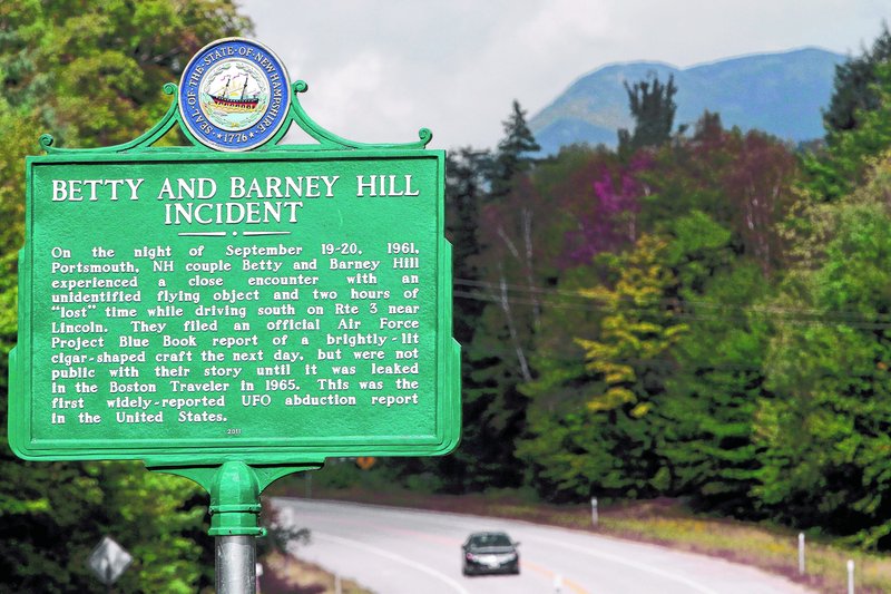 A car passes through Franconia Notch, where a state marker is seen. Betty and Barney Hill recalled through hypnosis that they were abducted by extraterrestrials here 50 years ago.