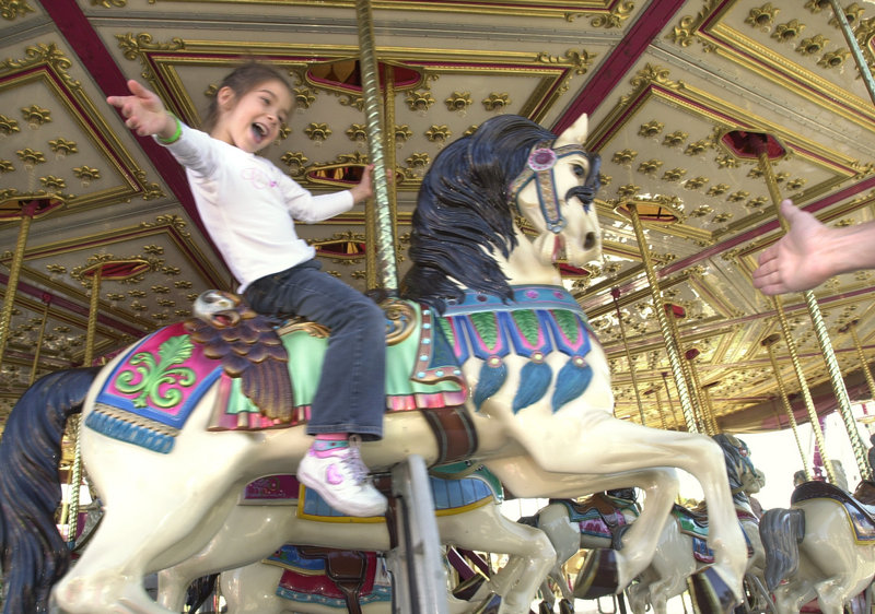 A youngster enjoys the carousel at the 2005 Cumberland County Fair.