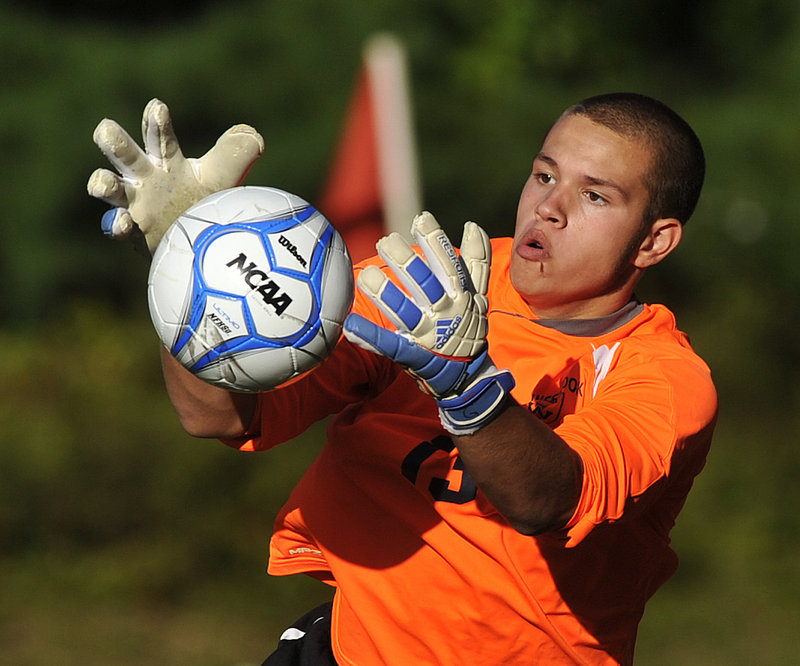 Westbrook goalkeeper Austin Blake keeps his eye on the ball as he makes a save on a shot by Sanford during their SMAA boys’ soccer match Monday afternoon in Westbrook. Blake finished with six saves as the Blue Blazes beat the Redskins, 4-2.