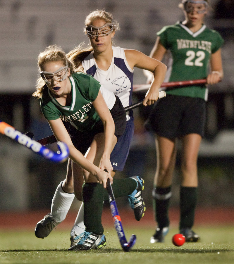 Waynflete’s Alexandra Armstrong keeps the ball away from a Yarmouth player during the Clippers’ 4-1 win Monday in Yarmouth.