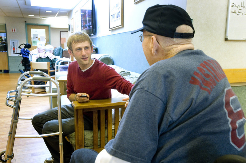 Architect Evan Carroll chats with a resident in the Alzheimer’s unit.