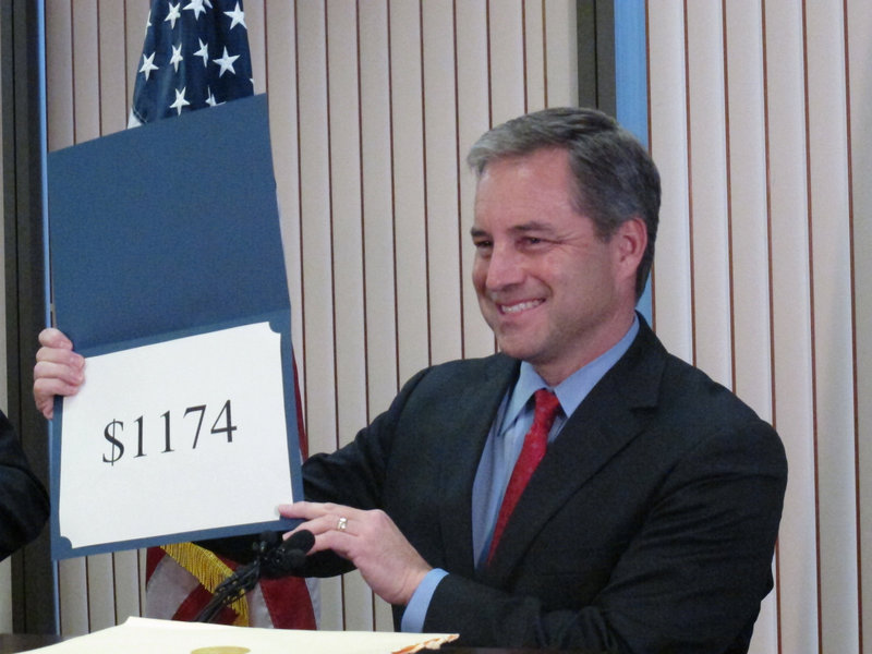 Alaska Gov. Sean Parnell reveals the amount of this year’s Permanent Fund Dividend checks Tuesday in Juneau.