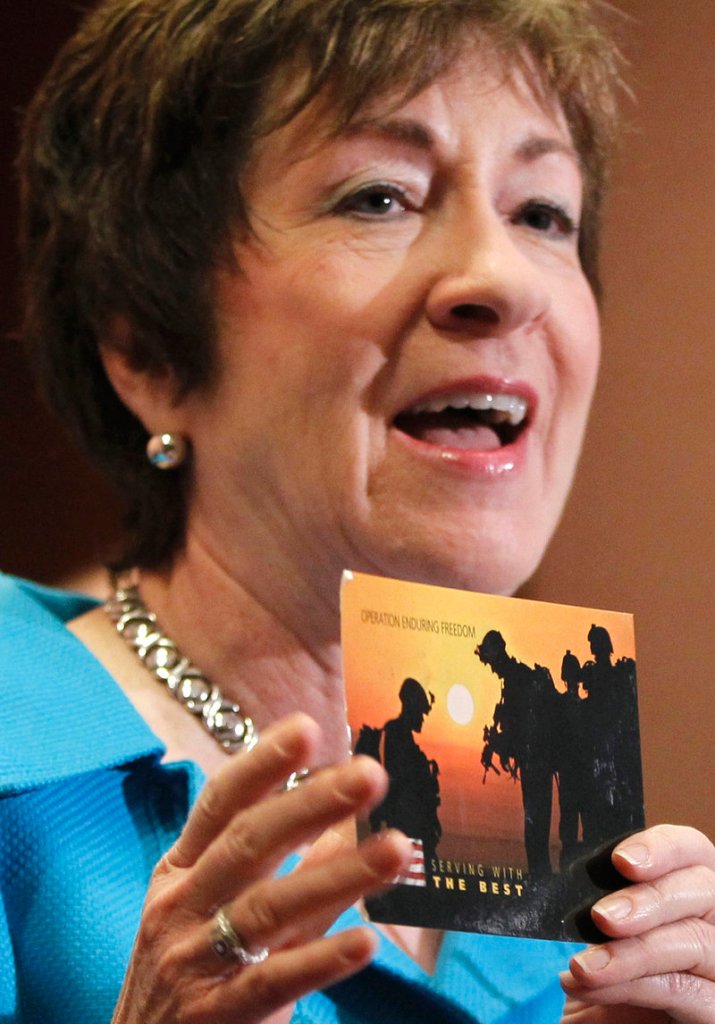 At a news conference Tuesday, Maine Sen. Susan Collins displays a postcard from an anonymous soldier in Afghanistan thanking her for supporting the repeal of “don’t ask, don’t tell.”