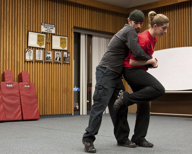 Coreena Behnke, a Portland police officer and an instructor for the Rape Aggression Defense program, demonstrates a self-defense technique with Richard Sparrow, also an instructor, during a recent class.