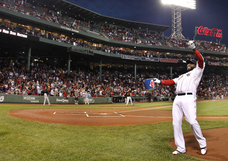 David Ortiz tosses baseballs into the stands Wednesday before the Red Sox played their final home game of the regular season. Boston blew a lead and lost to the Rays.