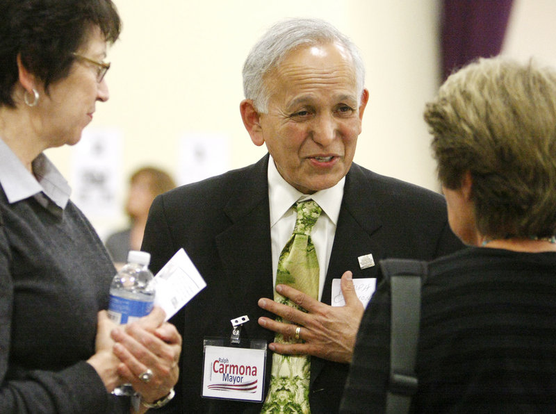 Ralph Carmona speaks with visitors during the "Meet the Mayoral Candidates" informal evening at Ocean Avenue Elementary School in Portland.