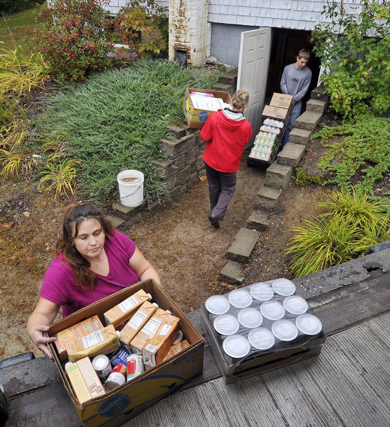 Volunteers with Casco Alliance Church unload a new delivery truck serving food pantries in the Lakes Region. From left, are Rachel Legere, Naples, Debbie Masters, Bridgton, and R.J. Legere, Naples.