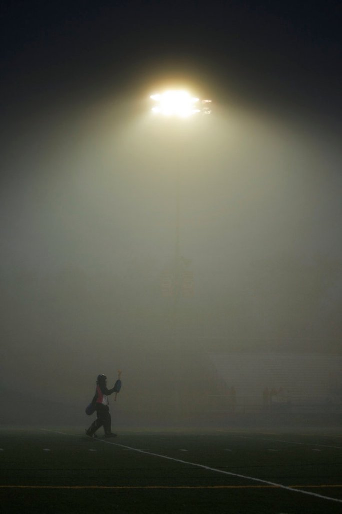 With the lights at the Mitchell Sports Complex in Scarborough showing just how foggy the night had become, Cheverus goalie Libby DesRuisseaux cheers on her teammates during a 2-1 loss to the Red Storm.