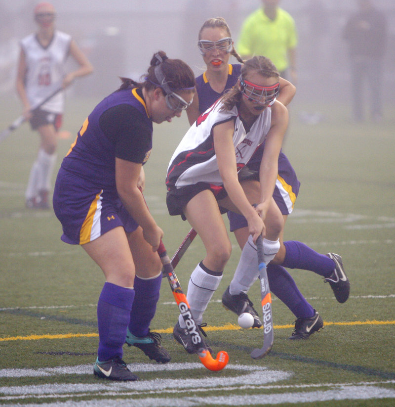 Annie DiLisio of Cheverus, left, and Grace Whelan of Scarborough attempt to control the ball Thursday night during Scarborough’s 2-1 victory in field hockey.
