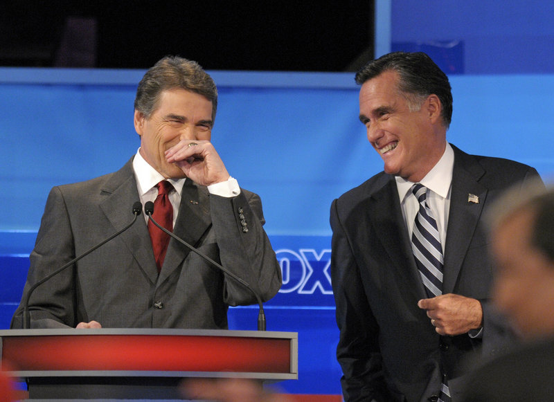 Candidates Texas Gov. Rick Perry, left, and former Massachusetts Gov. Mitt Romney share a light moment during a debate Thursday in Orlando, Fla. Romney and Perry were joined by seven other candidates: former Utah Gov. Jon Huntsman, Minnesota Rep. Michele Bachmann, Texas Rep. Ron Paul, former Pennsylvania Sen. Rick Santorum, former New Mexico Gov. Gary Johnson, former House Speaker Newt Gingrich and businessman Herman Cain.