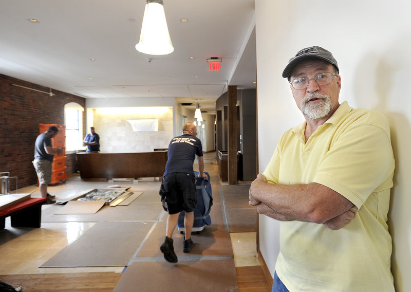 Facilities partner Dennis Keeler stands near the reception area Friday as the law firm Pierce Atwood moves into its fifth-floor offices.