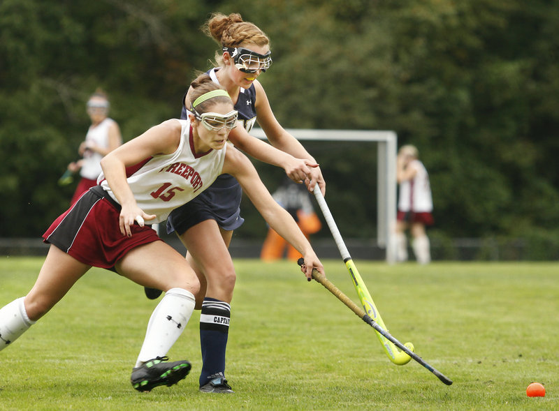 Katie Turner, front, of Freeport pushes the ball ahead of Traip Academy’s Anna Powers during their Western Maine Conference field hockey game Friday at Freeport. Turner scored the winning goal as the Falcons improved to 6-2 with a 3-2 victory.