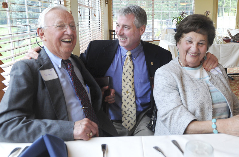 Paul Varga of Falmouth and Dorothy Derhagopian of Cumberland Foreside flank Dr. Kenneth Myers at the 10th anniversary of his “80/20 Club,” patients who have reached the milestone age of 80 and retained at least 20 of their own teeth.