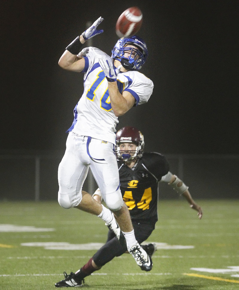 Will Sipperly of Falmouth leaps to make a catch in front of Cape Elizabeth’s Donald Clark. Cape Elizabeth handed the Yachtsmen their first loss of the season, 28-6.