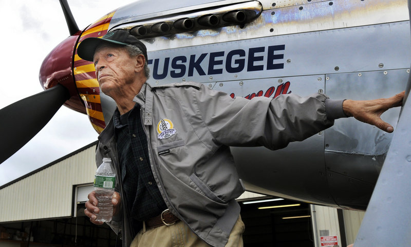 Jim Sheppard, 87, of South Portland checks out a Red Tail P-51C Mustang at the Biddeford airport Saturday. The World War II plane flew in to let Sheppard, a Tuskegee Airman, soar in the clouds again.