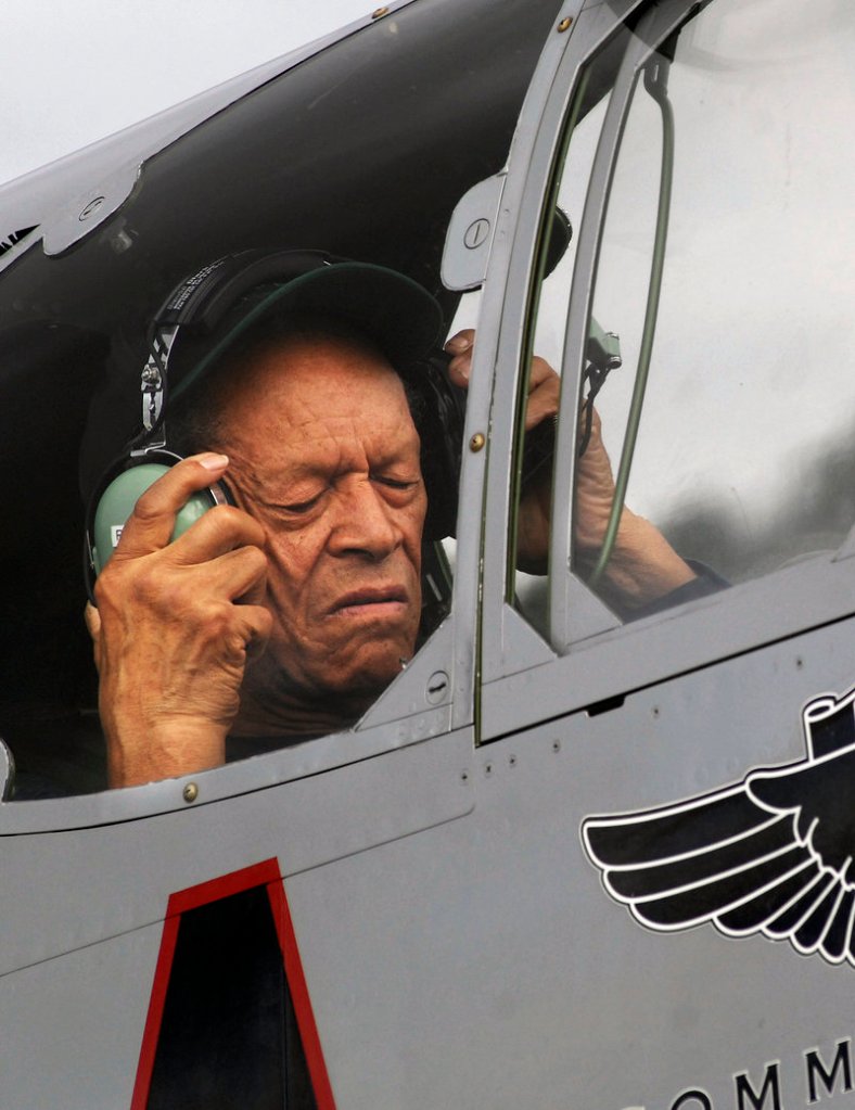 Jim Sheppard adjusts a headset aboard the Red Tail. The last time he flew in an airplane like it was 66 years ago at the end of World War II, during his combat service as a Tuskegee Airman, a member of the first all-black unit in what was then the U.S. Army Air Corps.