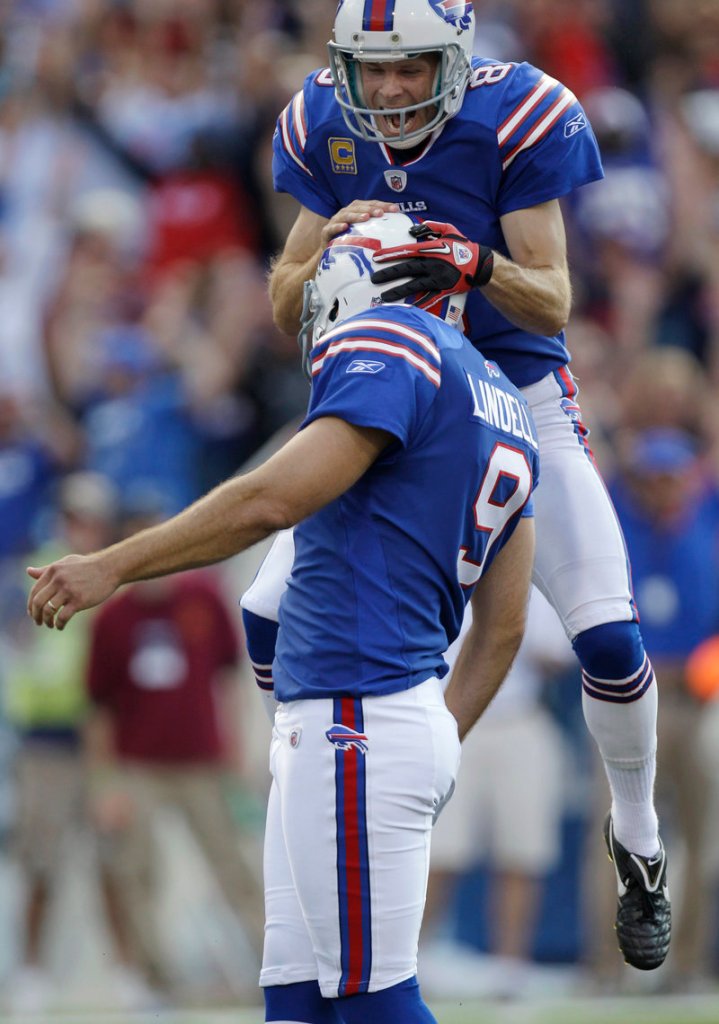 Bills kicker Rian Lindell, left, celebrates his winning kick with holder Brian Moorman as time runs out Sunday during their upset win over New England in Orchard Park, N.Y.