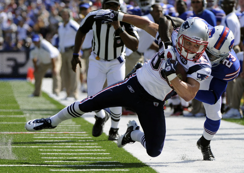 New England’s Wes Welker is brought down by Buffalo’s Aaron Williams on Sunday. Welker had 16 catches for a club-record 217 yards and two touchdowns.