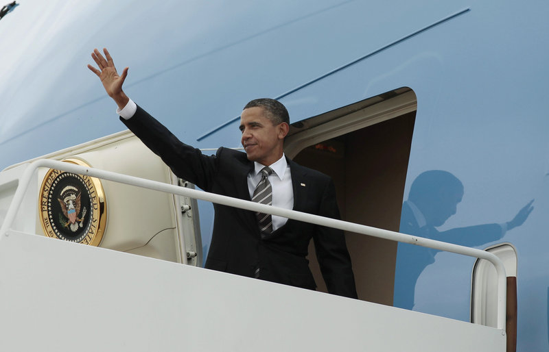 President Obama waves as he boards Air Force One before his departure from Andrews Air Force Base for the West Coast for several Democratic fundraisers Sunday.