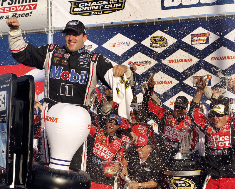 Tony Stewart and his crew celebrate his NASCAR Sprint Cup win at New Hampshire Motor Speedway in Loudon, N.H., on Sunday. Stewart now has a 7-point Chase lead.