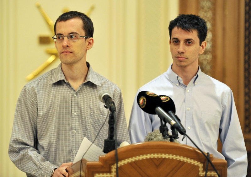 Freed American hikers Shane Bauer, left, and Josh Fattal speak to reporters before leaving for the United States at the airport in Muscat, Oman, on Saturday.