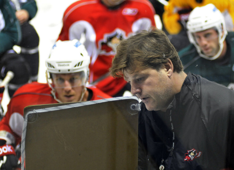 Pirates Coach Ray Edwards draws up a drill for the Pirates on opening day of the training camp Monday at the Cumberland County Civic Center. Some players will earn a spot on the Pirates' roster, while some will be placed with the ECHL's Gwinnett Gladiators.